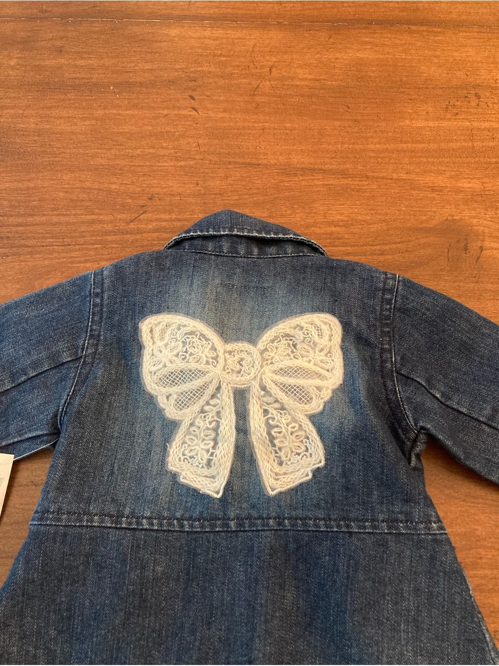 Girls' boutique Denim Jacket with lace bow appliqué on back.